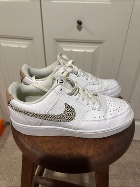Nike White Low-Top Sneakers with Tan Patterned Swoosh